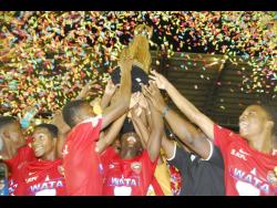 Members of the Cornwall College football team  celebrate with the ISSA Champions Cup after they clipped Jamaica College 1-0 in last season’s final at the Montego Bay Sports Complex.