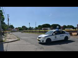Police cordon off a section of Waltham Park Road after lawmen shot and killed a gunman in the Chinese Cemetery yesterday.