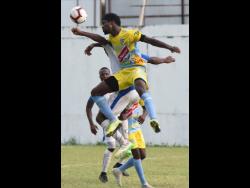 Colorado Murray (right) from Waterhouse FC jump high to head during their Red Stripe Premier League football match at the Spanish Town Prison Oval on November 10, 2019.