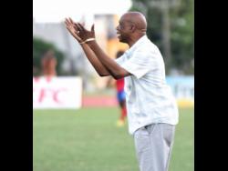 Leebert Halliman, coach of Excelsior High School, gesticulates to his players during their Walker Cup semi-final football match against Camperdown High  on November 21, 2019.