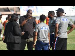 Tivoli and Waterhouse officials in discussion with match commissioner before their Red Stripe Premier League match was called off on December 1.