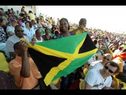 below: Spectators beam with joy at the opening ceremony of the 2007 Cricket World Cup at the Trelawny Multipurpose Stadium.