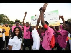 Shelly-Ann Fraser-Pryce presents the winning trophy to Legacy United at the Shelly-Ann Fraser-Pryce Six-A-Side final at Foska Oval at 451 Spanish Town Road in Kingston, yesterday.
