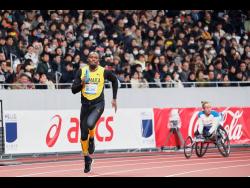 In this photo provided by Japan Sports Council (JSC), Olympic gold medallist Usain Bolt (left) of Jamaica runs at the opening ceremony of the new National Stadium, the main venue for the Tokyo 2020 Olympic and Paralympic Games, in Tokyo, Japan, on December 21, 2019. 