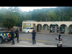 Credit: Hopeton Bucknor Police personnel at the crime scene in Sandy Bay, Hanover, on Monday.