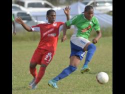 Montego Bay United’s Keniel Kirlew (right) dribbles away from Boys’ Town’s Shawn McKoy during their Red Stripe Premier League match at the Barbican field on Wednesday, January 17, 2018.