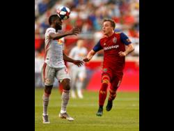 New York Red Bulls defender Kemar Lawrence (left) heads the ball in front of Real Salt Lake forward Corey Baird during the first half of an MLS match Saturday, June 1, 2019, in Harrison, N.J.