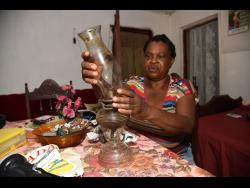 Rebecca Caballera, a resident of British in Clarendon, could soon bid her Home Sweet Home lamp goodbye as a solar project is set to take electricity to her community for the first time at last.