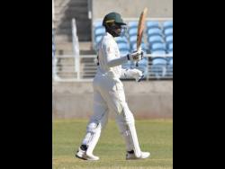 Jamaica Scirpions’ Nkrumah Bonner raises hit bat after scoring a century in the CWI Regional Four Day cricket match against the Windward Islands Volcanoes at Sabina Park on January 19.