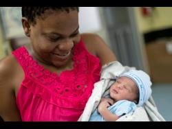 Davia Goulburne holds her son Hasanio Gayle, one of several Leap Day babies born at the Victoria Jubilee Hospital in Kingston on Saturday.