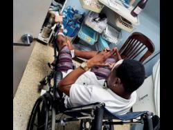 Selector Bishop Escobar sits in a wheelchair in the hospital awaiting medical attention.