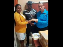 Clint Rennie (centre) donates cheque for $163,000 to the Falmouth Infirmary. Accepting the cheque is matron Tracey-Ann McGlashan and Andrew Harrison of The Trelawny Municipal Corporation. 