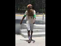 Derrick ‘Black X’ Robinson is known from walking around Jamaica. He is urging Jamaicans to do like him and stay home.