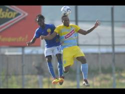Waterhouse defender Shawn Lawes (right) engages Vere United defender Devroy Grey in an aerial battle for possession during their Red Stripe Premier League game at the Drewsland Stadium on Thursday, September 12, 2019.