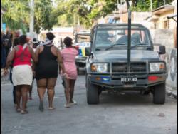 A Jamaica Defence Force patrol vehicle parked in Craig Town following the shooting of seven children on Saturday. 