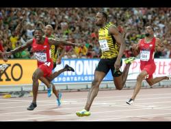 Usain Bolt, right, wins the gold medal in the men’s 100m ahead of United States’ Justin Gatlin, left, at the World Athletics Championships at the Bird’s Nest stadium in Beijing. 