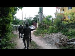 Soldiers make their way to the crime scene in Grinnion Land.