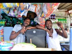 Credit: Kenyon Hemans Clifford Blygen (left) and Kemar Salmon have resorted to living in their place of business to keep themselves financially afloat.