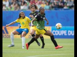 Allyson Swaby (right) makes a pass ahead of teammate Marlo Sweatman (centre) and Beatriz Zaneratto Joao of Brazil during Jamaica’s FIFA Women’s World Cup match against Brazil at the Stade des Alpes in Grenoble, France, on Sunday, June 9, 2019.