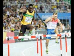Green (left) clears a hurdle in the preliminary round of the men’s 400m hurdles at the World Championships in Daegu in 2011.