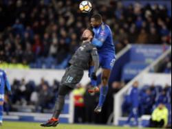 Chelsea's Olivier Giroud is airborne with Leicester City's Wes Morgan (right) during their English FA Cup quarterfinal match at the King Power Stadium in Leicester, England on Sunday, March 18, 2018.