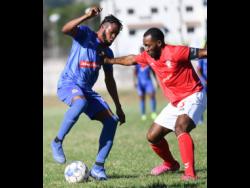 Action from the Red Stripe Premier League as Dunbeholden’s Deandre Thomas (left) takes on UWI FC’s Fabion McCarthy in a match at the UWI Mona Bowl on Sunday, January 12.
