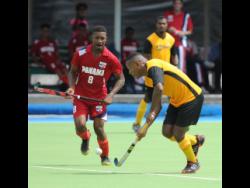 Credit: Ricardo Makyn Jamaica’s Nicholas Beach dribbles by Panama’s Angelo Boodie in the Central American and Caribbean Games qualifier at the Mona hockey field on November 5, 2017.