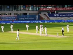 Players leave the field at the end of the first day of the second cricket Test match between England and West Indies at Old Trafford in Manchester, England, Thursday, July 16, 2020. 