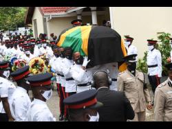 A bearer party carry the coffin with the remains of Decardo Hylton from the Bread of life Ministries in Linstead, St Catherine, on Saturday.