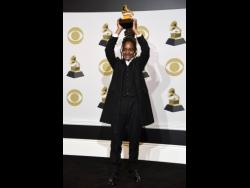 Koffee raises aloft the award for Best Reggae Album for ‘Rapture’ at the 62nd annual Grammy Awards at the Staples Center in Los Angeles this year.