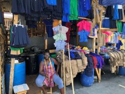 Sonia sits outside her vending area, hoping for sales.