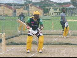 Jamaica Tallawahs captain Rovman Powell (centre) bats during a training session at the UWI ground in Trinidad and Tobago. Looking on are Jermaine Blackwood (left) and Nkrumah Bonner. 