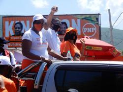 The People’s National Party’s Phillip Paulwell, who has been the Member of Parliament for East Kingston and Port Royal for the past 23 years, on his way to the nomination centre on Windward Road yesterday. He is flanked by councillors Loraine Dobson (left) and  Jacqueline Lewis.