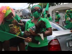JLP supporters bring out even their dog to cheer for Marlene Malahoo Forte as she seeks to retain the St James West Central seat.