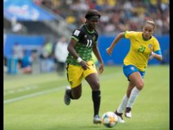 File
Khadija Shaw (left) dribbles the ball away from Brazil’s Monica last year in the FIFA Women’s World Cup.