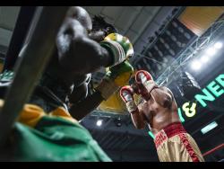 File
Richard Holmes (left) leans against the ropes as Ricardo Salas attacks in the final of the Wray and Nephew Contender 2018 competition.