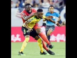 File
United States forward Jozy Altidore (17) collides with Jamaica forward Junior Flemmings (12) after Altidore passed the ball during the first half of a Concacaf Gold Cup semi-final  match on Wednesday, July 3, 2019.