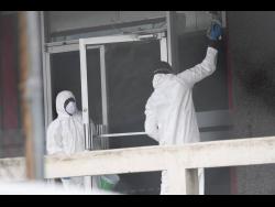 A sanitisation crew cleaning the exterior of the Central Sorting Office building in Kingston in April.