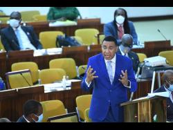 Prime Minister Andrew Holness speaking at the sitting of the House of Representatives at the Jamaica Conference centre on Tuesday.
