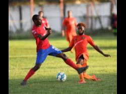 File
Dunbeholden’s Kevin Reid challenges Tivoli Gardens’ Jamie Robinson for the ball during a premier league match at the Edward Seaga Sports Complex on October 20, 2019.