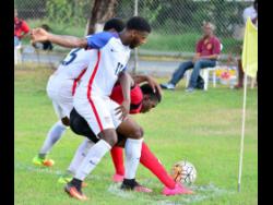File
Zyen Jones of the USA (centre) challenges Arnett Gardens’ Anthony Thompson for the ball in an Under-20 match at Jamaica College on November 4, 2016. 