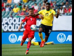 Jamaica’s Damion Lowe (right) and Panama’s Gabriel Torres battle for the ball during the first half of a Concacaf Gold Cup match in Philadelphia last year.  