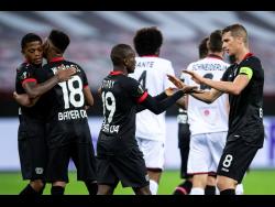 Leverkusen’s Leon Bailey, Wendel, goal scorer Moussa Diaby and Lars Bender, from left, cheer after the goal for the 3:1 during the Europa League group C match between Bayer Leverkusen and OGC Nice in Leverkusen, Germany, last Thursday.
