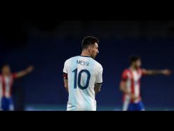 Argentina’s Lionel Messi stands on the field during a qualifying match against Paraguay for the FIFA World Cup Qatar 2022 in Buenos Aires, Argentina, Thursday, November 12, 2020.