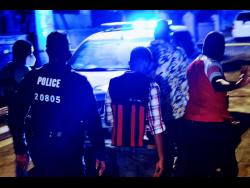 Credit: Anthony Minott/Photographer Police personnel investigate the triple murder in Tryall Heights, near Lauriston, St Catherine, on Sunday evening. Two girls and their grandmother were slain.