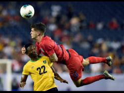 United States midfielder Christian Pulisic (10) heads the ball above Jamaica midfielder Devon Williams (22) during the second half of a Concacaf Gold Cup semifinal soccer match Wednesday, July 3, 2019.