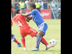 File
Kemar Beckford (right) of Mount Pleasant shoves Kemar Flemmings (left) off the ball during a Premier League match on March 31, 2019.