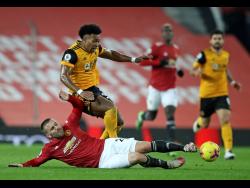 Manchester United’s Luke Shaw challenges Wolverhampton Wanderers’ Adama Traore during the English Premier League match between Manchester Utd and Wolverhampton Wanderers at Old Trafford stadium in Manchester, England, yesterday.