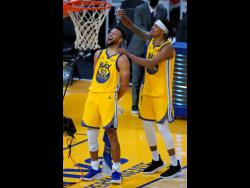 Golden State Warriors guard Damion Lee pours water over the head of guard Stephen Curry while celebrating Curry’s career-high 62 points against the Portland Trail Blazers in an NBA game in San Francisco on  Sunday, January. 