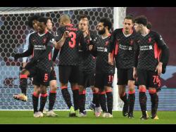 Liverpool’s Mohamed Salah celebrates after scoring his side’s fourth goal during the FA Cup third-round match against Aston Villa at Villa Park stadium in Birmingham, England, on Friday, January 8.